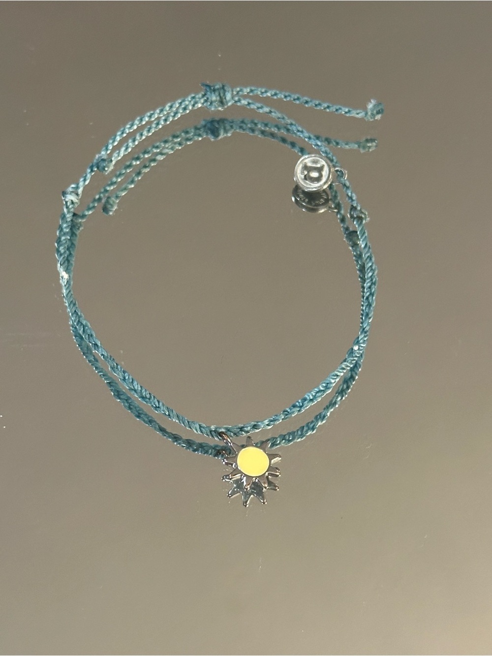Pura Vida. Teal Braided Cord Bracelet with Yellow Sun Charm